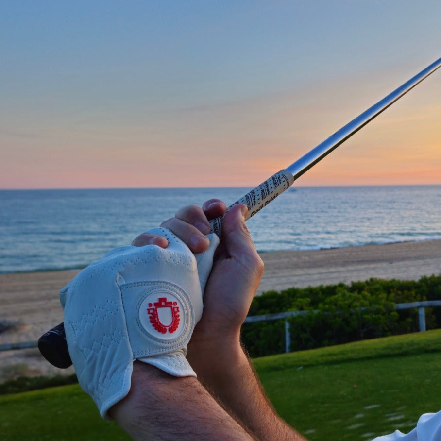 Image showing the ITR Classic golf glove on Josh's hand with the horizon of Vale Do Lobo in the background